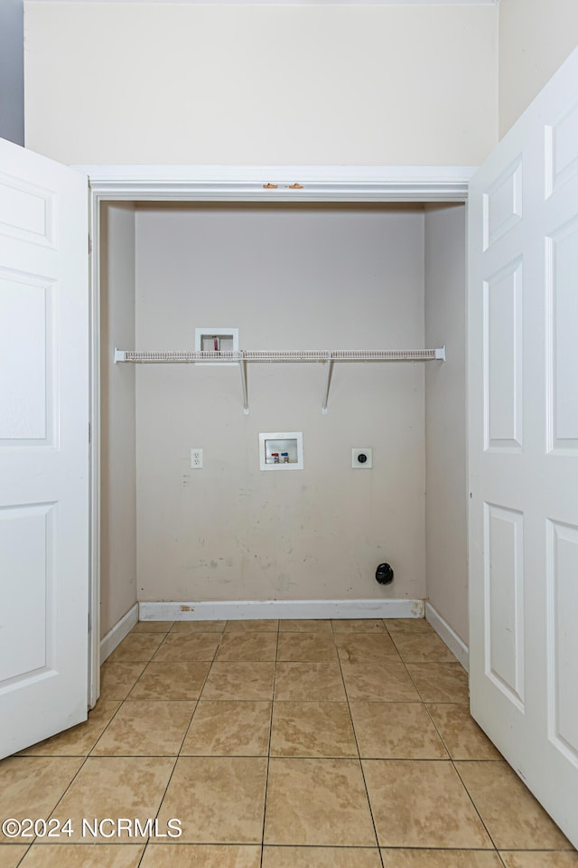 washroom with electric dryer hookup, washer hookup, and light tile patterned floors