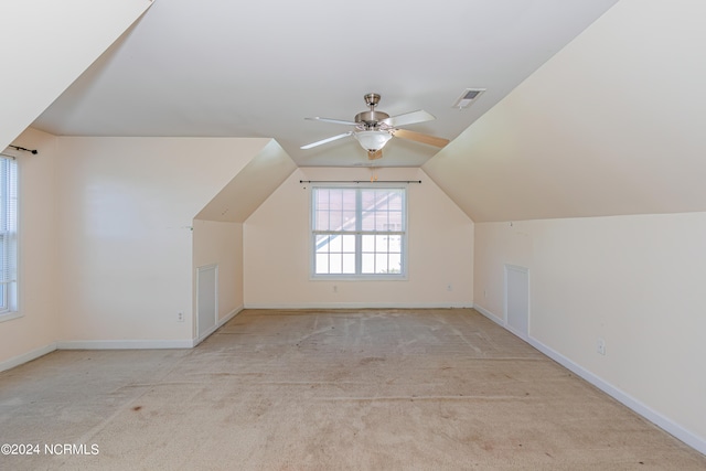 bonus room with ceiling fan, vaulted ceiling, and light colored carpet