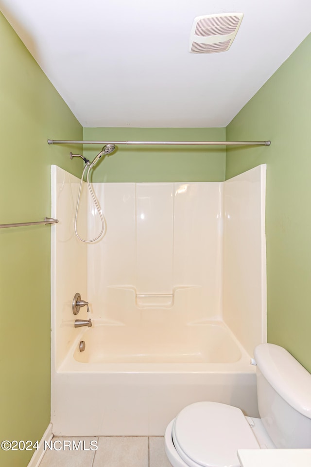 bathroom with toilet, tile patterned floors, and  shower combination