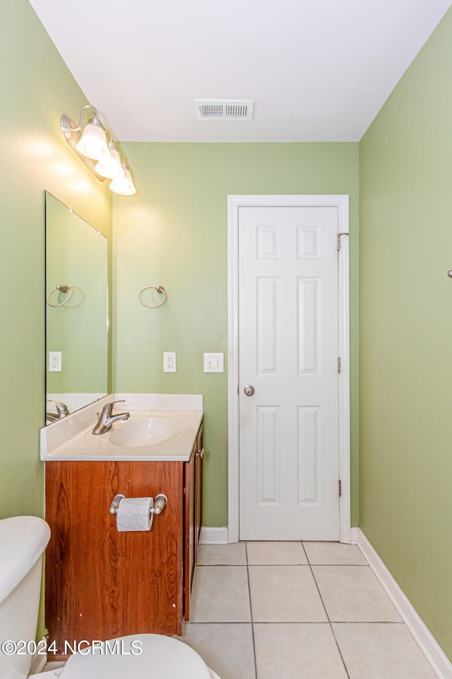 bathroom featuring vanity, toilet, and tile patterned floors