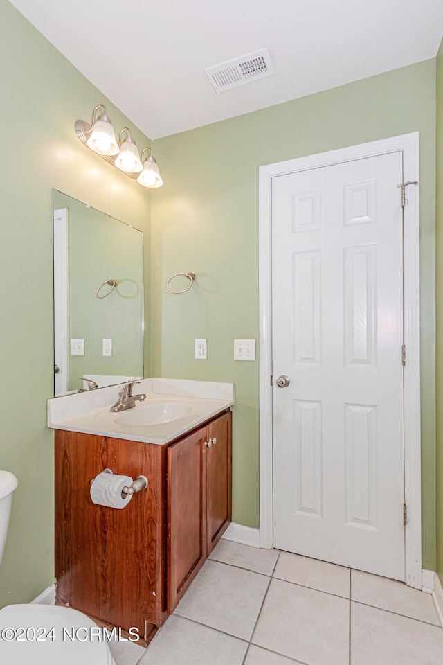 bathroom featuring vanity, toilet, and tile patterned floors