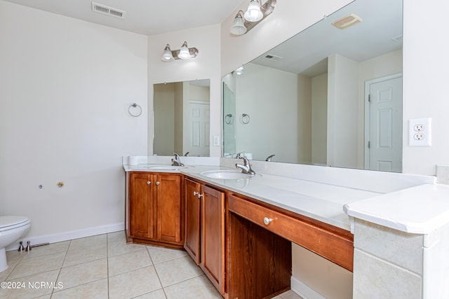 bathroom featuring vanity, toilet, and tile patterned floors