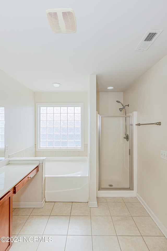 bathroom featuring vanity, tile patterned flooring, and plus walk in shower