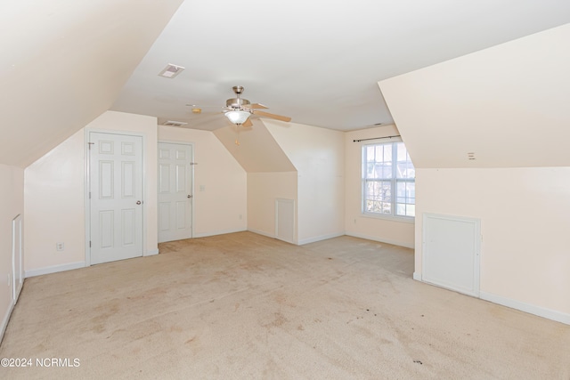 bonus room with ceiling fan, light colored carpet, and vaulted ceiling