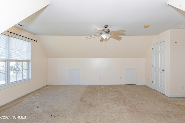 bonus room featuring light carpet, lofted ceiling, and ceiling fan