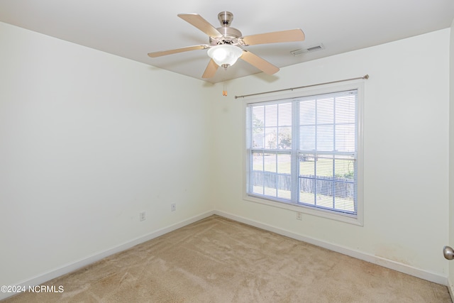 carpeted empty room featuring ceiling fan