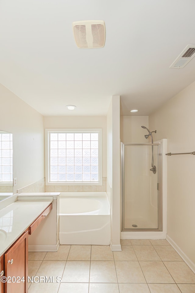 bathroom featuring vanity, independent shower and bath, and tile patterned flooring