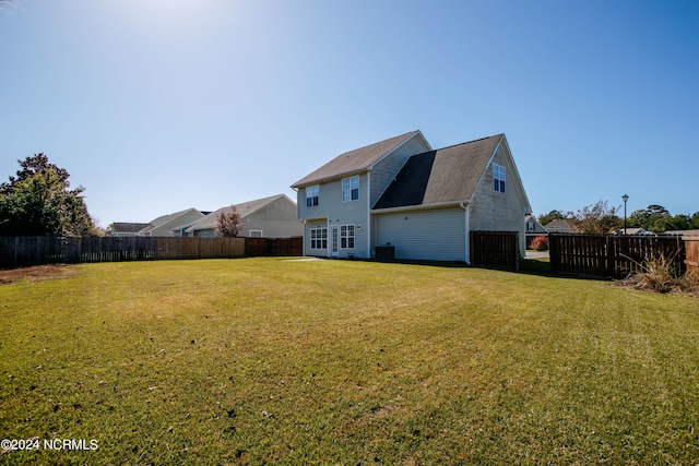 back of property with a lawn and central AC unit