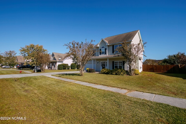 view of front of property with covered porch and a front lawn