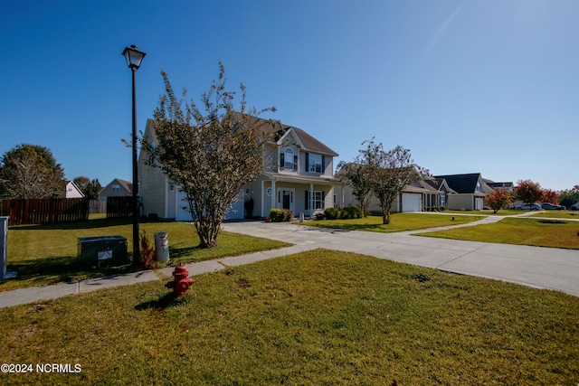 view of front of home featuring a front yard, a porch, and a garage