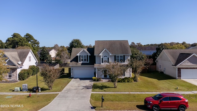 view of property with a front lawn and a garage