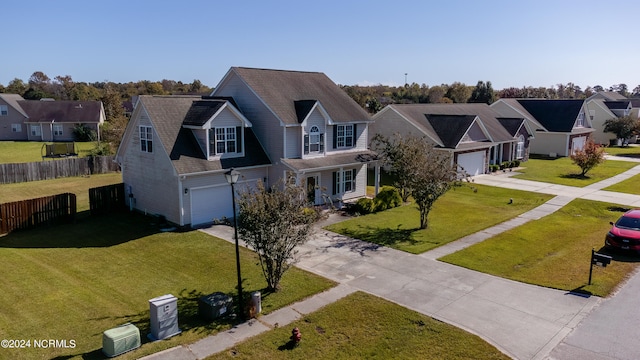 view of front of home featuring a front yard and a garage