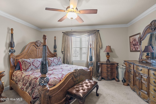 carpeted bedroom with ceiling fan and ornamental molding