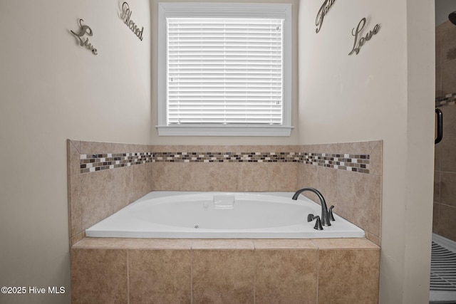 bathroom featuring tiled bath