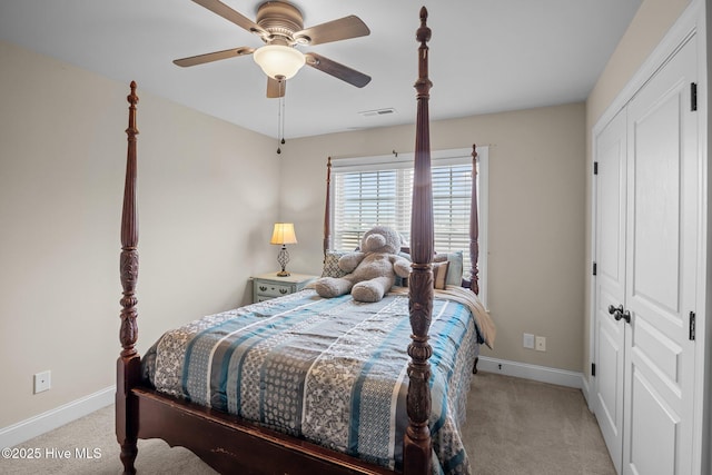 bedroom featuring ceiling fan, light colored carpet, and a closet