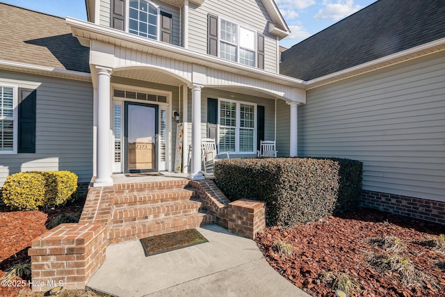 view of exterior entry with covered porch