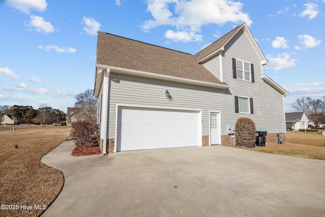 view of side of home featuring a lawn and a garage