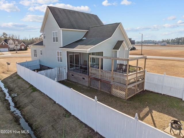 rear view of house with a wooden deck