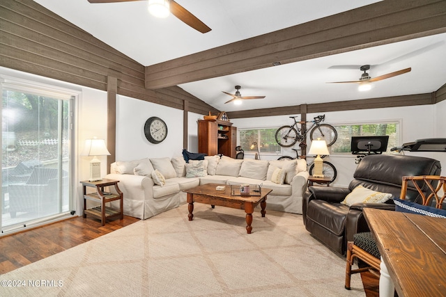 living room with lofted ceiling, hardwood / wood-style floors, and ceiling fan with notable chandelier