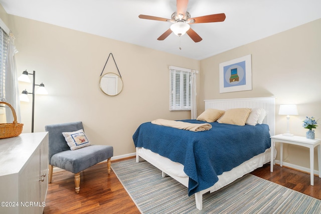 bedroom featuring ceiling fan and dark hardwood / wood-style floors