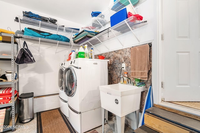 clothes washing area with washing machine and clothes dryer and sink