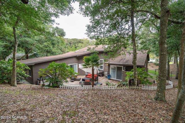 rear view of property featuring a patio area and an outdoor hangout area