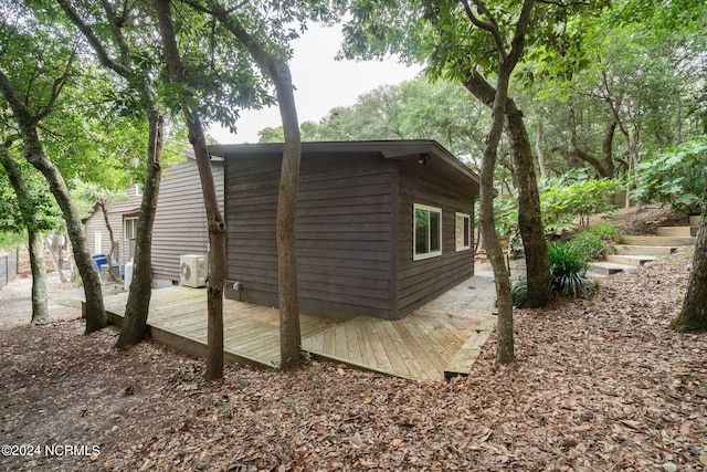 view of property exterior with ac unit and a deck