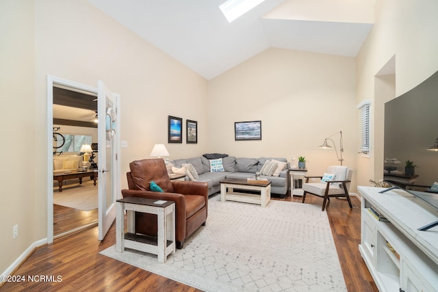 living room with dark hardwood / wood-style floors and lofted ceiling with skylight