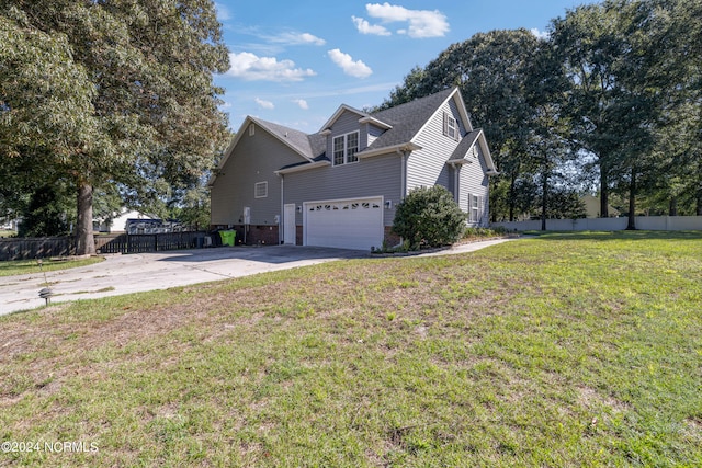 view of front of house with a garage and a front lawn