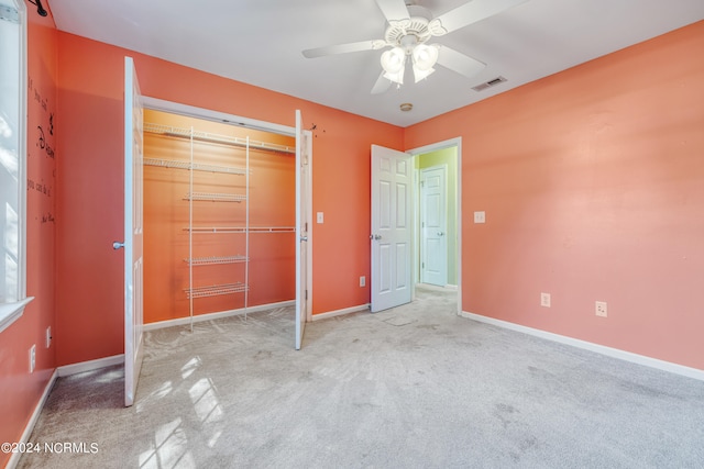 unfurnished bedroom featuring carpet flooring, a closet, and ceiling fan