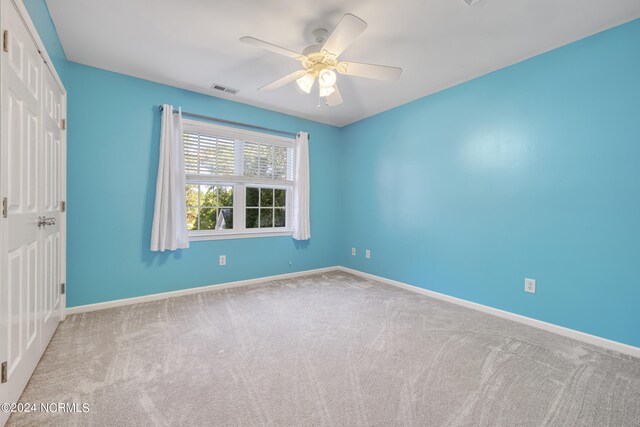 carpeted empty room with ceiling fan