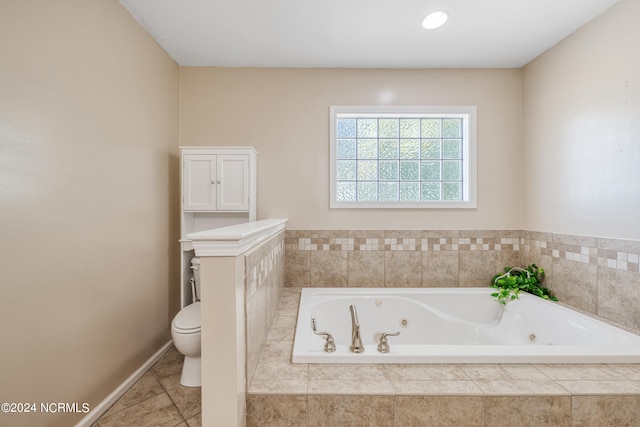 bathroom with toilet and tiled tub