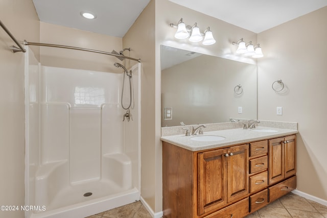 bathroom with vanity, a shower, and tile patterned floors