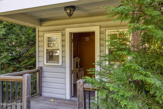 view of exterior entry with a deck