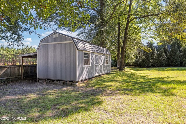 view of outbuilding featuring a yard