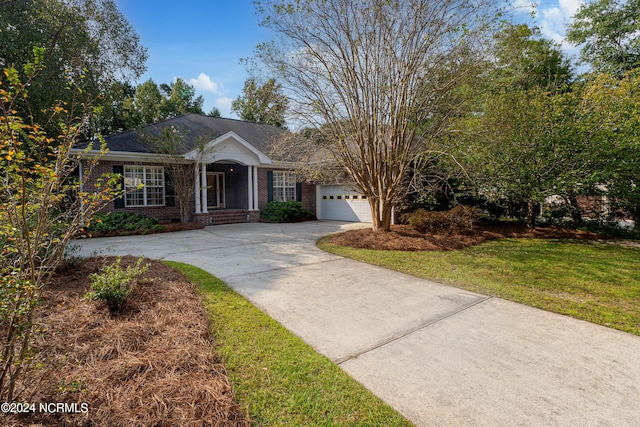 single story home featuring a garage and a front yard