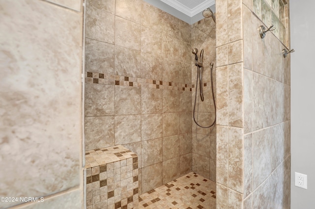 interior space with ornamental molding and a tile shower