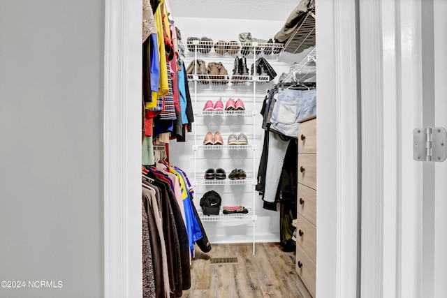 spacious closet featuring light hardwood / wood-style flooring