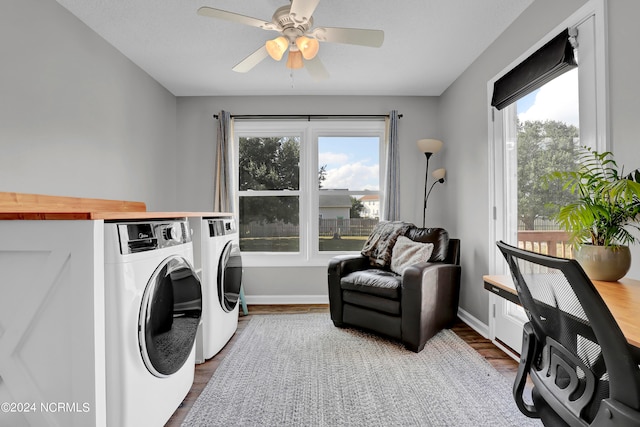 laundry room featuring ceiling fan, plenty of natural light, dark hardwood / wood-style floors, and washing machine and clothes dryer