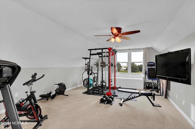 exercise area featuring vaulted ceiling, light carpet, and ceiling fan