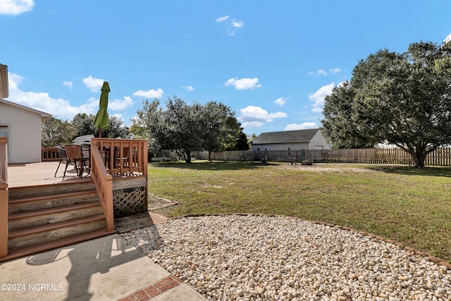 view of yard featuring a wooden deck