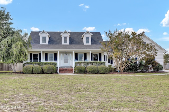 cape cod house with a porch and a front lawn