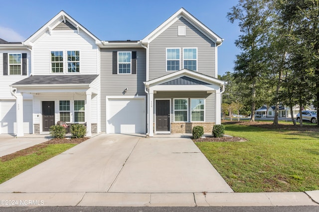 view of front of property with a front yard and a garage