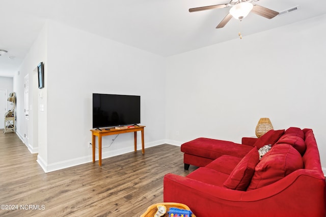 living room featuring ceiling fan and hardwood / wood-style flooring