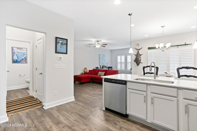 kitchen featuring white cabinetry, ceiling fan with notable chandelier, dishwasher, pendant lighting, and sink