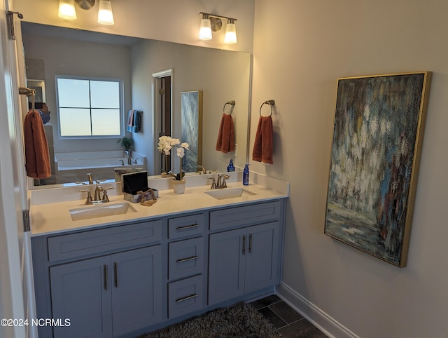 bathroom with tile patterned flooring, a bathing tub, and vanity