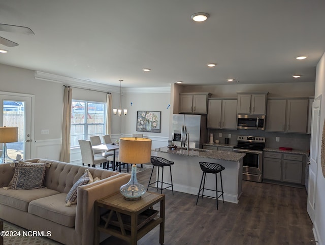 living room featuring ornamental molding, dark hardwood / wood-style flooring, plenty of natural light, and sink