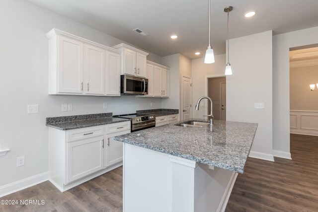 kitchen with white cabinetry, sink, light stone counters, decorative light fixtures, and appliances with stainless steel finishes