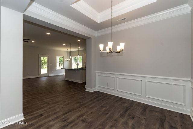 unfurnished dining area with ornamental molding, ceiling fan with notable chandelier, a raised ceiling, and dark wood-type flooring