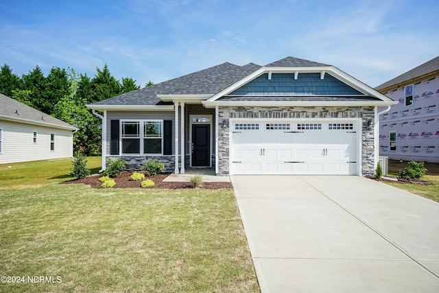 view of front of property featuring a garage, stone siding, roof with shingles, and driveway